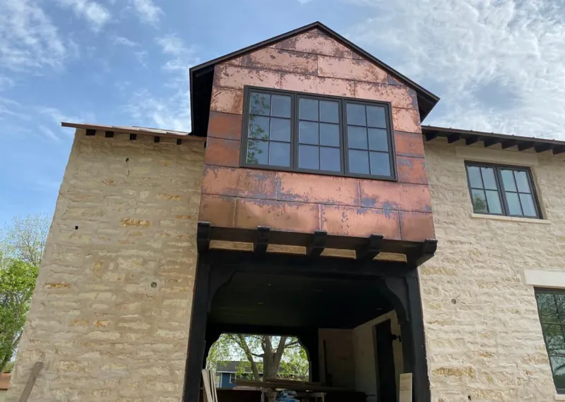 Copper metal panel facade on a stone building for Skylight Installation in Vacaville